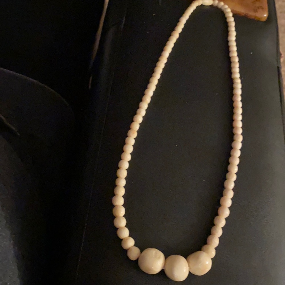 Unique necklace. Ivory colored wooden or special lightweight stone ?? Beads.